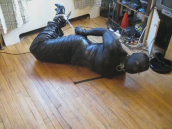 Cuffs Chains Rope And Hogtie - Vanessa fetish is cuffed and chained in a hogtie, wearing hobble dress, corset and hood, while tape gagged underneath the hood